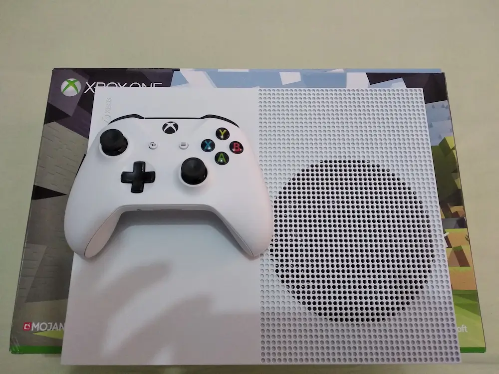 A pawn shop employee testing the condition of an Xbox One console.